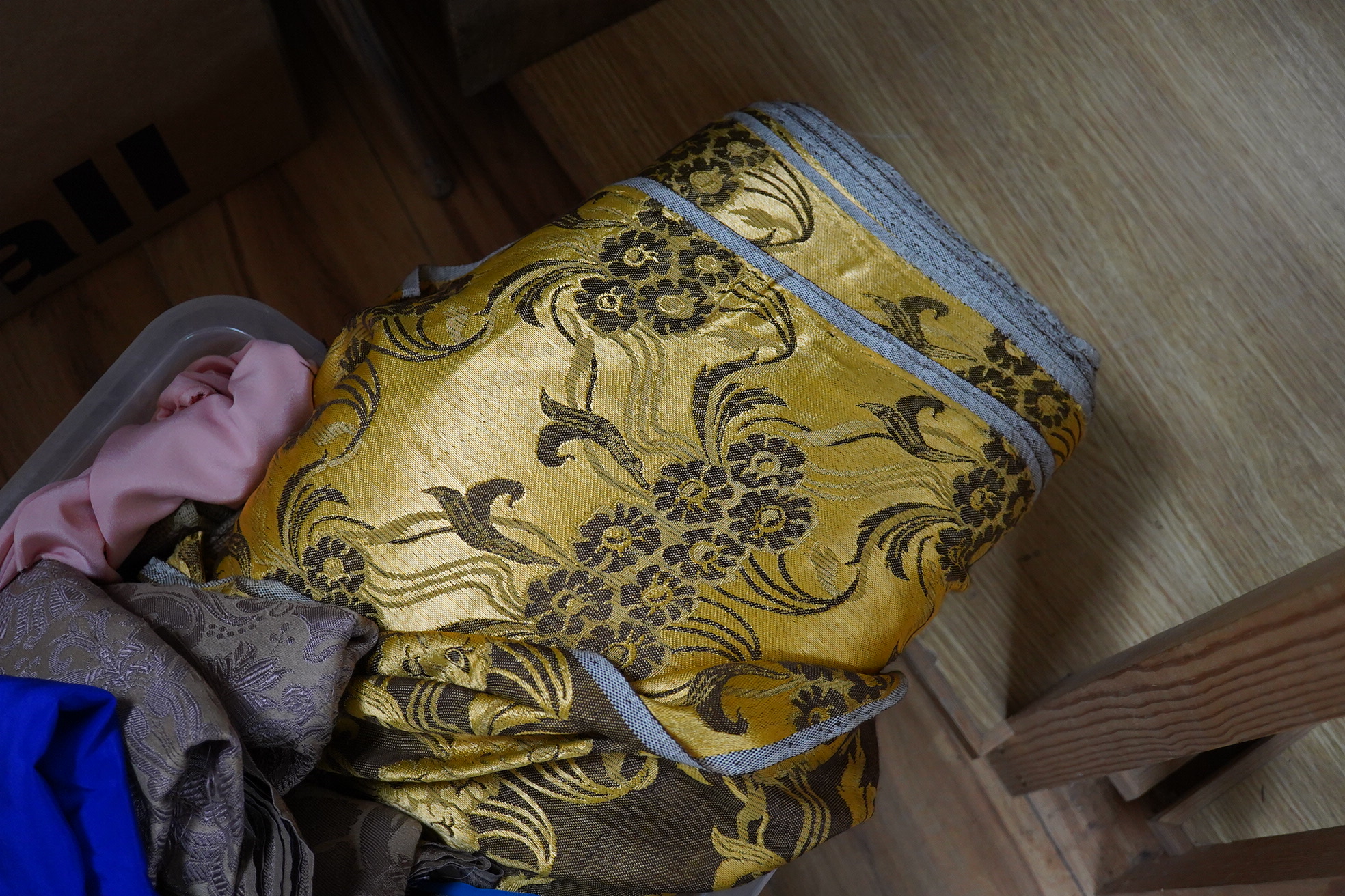 A roll of gold and brown floral curtain fabric, circa 1970-80's and various lengths of silk and other fabrics from 60-70's